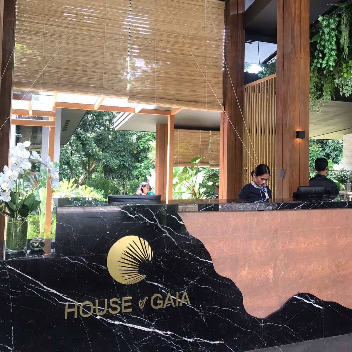 Reception lobby with a black marble feature wall and timber details